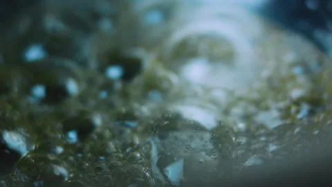 Vibrant cooking study of sugar bubbles forming across the saucepan Stock Footage 342153992