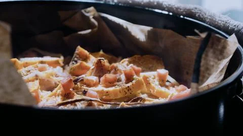 Vibrant culinary close-up: arranging the mixture in a baking dish Stock Photos