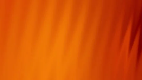 Vibrant dark orange gradient background with soft, blurred vertical lines. Video stock 283374081