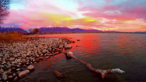 Vibrant dark red sunset dusk sky clouds flying over water aerial view Stock Footage 276607750