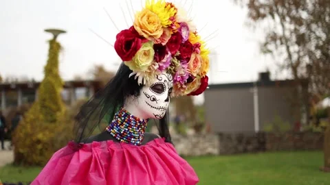 A vibrant Day of the Dead display featuring a skull figure with intricate face p Stock Footage 289655723
