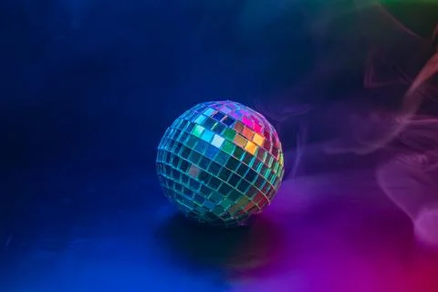 A vibrant disco image with a rotating ball, encompassed by colorful swirls Th Stock Photos