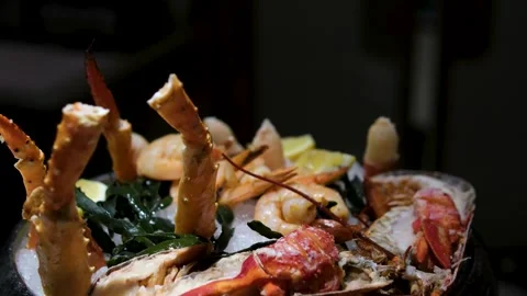 A vibrant display of assorted seafood is showcased, featuring fish, shrimp, and Stock Footage 303482659