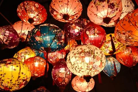 A vibrant display of colorful patterned lanterns illuminating a dark space Photos