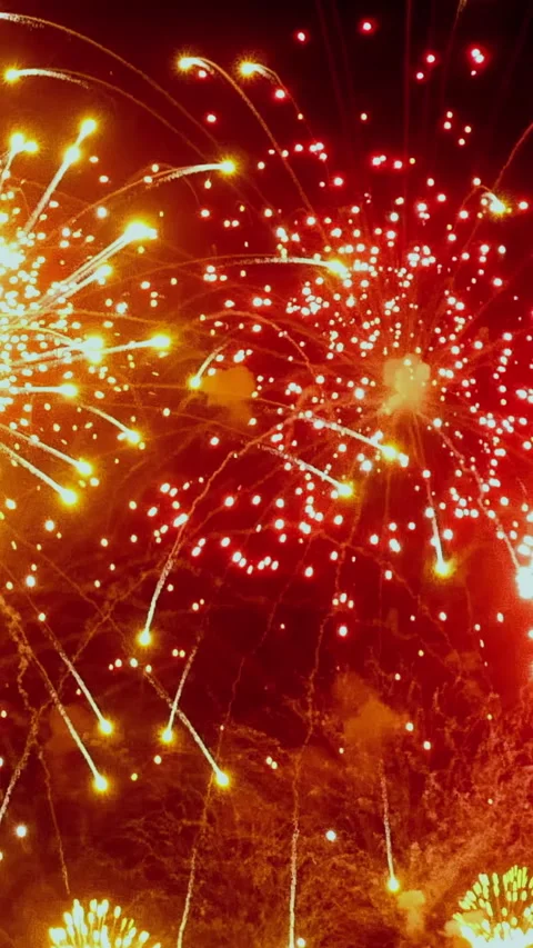 A vibrant display of fireworks lighting up the night sky at a summer festival Video stock 334918507