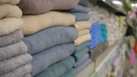 A vibrant display of neatly stacked, multi-colored towels arranged perfectly on Stock Footage 318947266