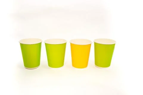 Vibrant Disposable Paper Cups: Green and Yellow Colors on a White Backdrop Stock Photos