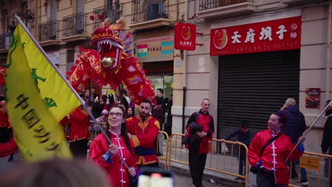 Vibrant dragon dance parading through Valencia streets during Chinese Lunar New Stock-Footage 319884505