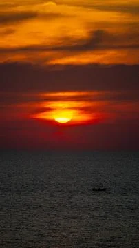 Vibrant dramatic orange sunset, dark water in Koh Lanta, Thailand Stock Photos