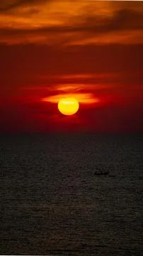 Vibrant dramatic orange sunset, dark water in Koh Lanta, Thailand Stock Photos