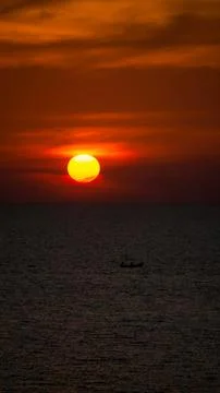 Vibrant dramatic orange sunset, dark water in Koh Lanta, Thailand Stock Photos