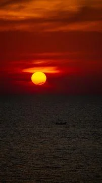Vibrant dramatic orange sunset, dark water in Koh Lanta, Thailand Stock Photos