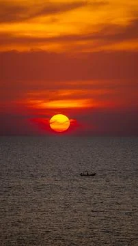 Vibrant dramatic orange sunset, dark water in Koh Lanta, Thailand Stock Photos