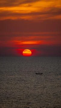 Vibrant dramatic orange sunset, dark water in Koh Lanta, Thailand Stock Photos