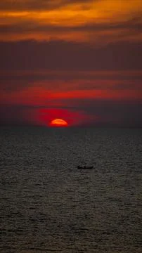 Vibrant dramatic orange sunset, dark water in Koh Lanta, Thailand Stock Photos