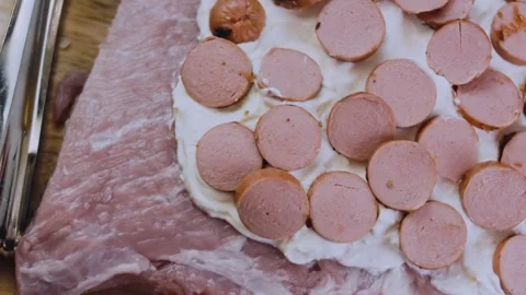 Vibrant dynamic preparation: slicing cooked sausage into rounds Stock Footage 342184515