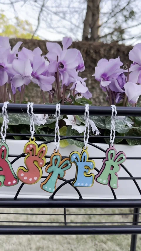 Vibrant easter decorations sway in the breeze with blooming flowers in the .. Stock Footage 317774899