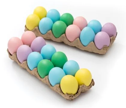 Vibrant Easter eggs in a crate on a seamless white background Fotos de archivo