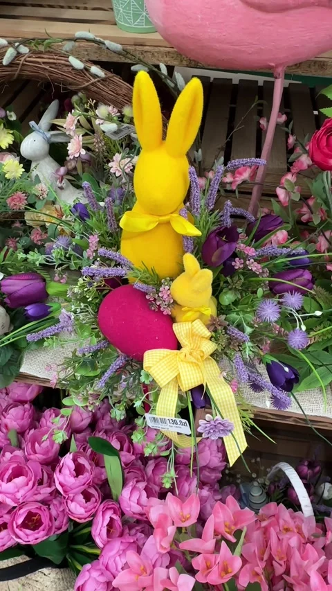 A vibrant Easter floral arrangement featuring yellow plush bunnies, colorful Stock Footage 313005469