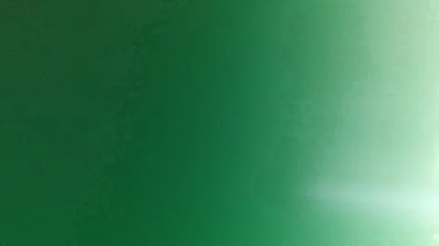 A vibrant emerald green gradient background featuring a luminous effect. Idea Stock Photos