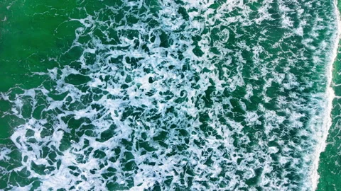 Vibrant emerald sea water with dense white foam pattern Stock Footage 336340980