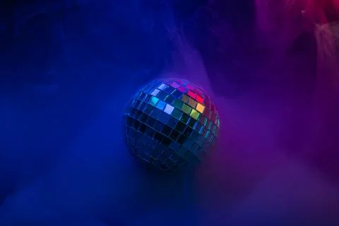 A vibrant, energetic image showcasing a disco ball amidst swirling smoke in.. Stock Photos