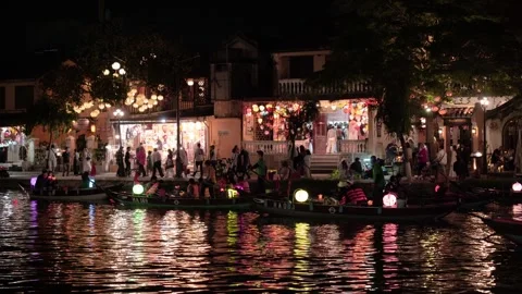 A vibrant evening scene along the river in Hoi An, Vietnam 動画素材 326208882