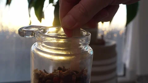 Vibrant extreme close-up of fresh fruit tea being scooped out from a glass jar Stock Footage 303606563