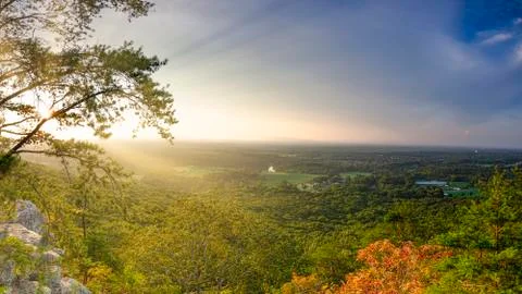 Vibrant fall landscape during sunset with Sun rays in Georgia Mountains Stock Photos