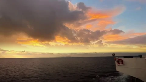Vibrant Fiery Cloudscape from Ship Deck over Open Sea Horizon Stock Footage 320034472