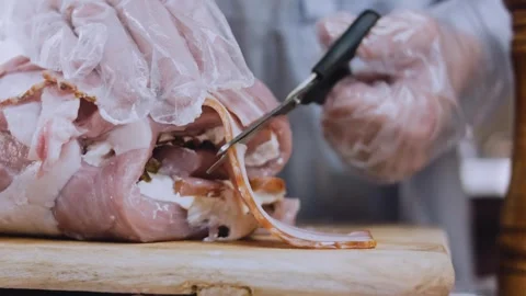 Vibrant finished dish: arranging bacon strips under stuffed pork Stock Footage 342184740