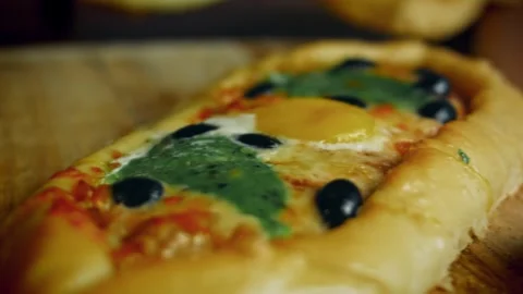 Vibrant finished pide topped with spinach olives and pepper in low angle, 4K Stock Footage 341114547