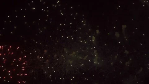A vibrant fireworks display lights up the night sky with golden and orange hues Stock Footage 330377072