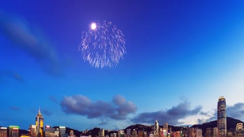 A vibrant fireworks display over Hong Kong's skyline at twilight. The city Stock Footage 344105857