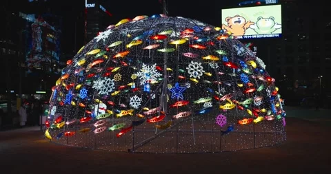 Vibrant fish lanterns and snowflake patterns on glowing Christmas dome Seoul Stock Footage 327323480