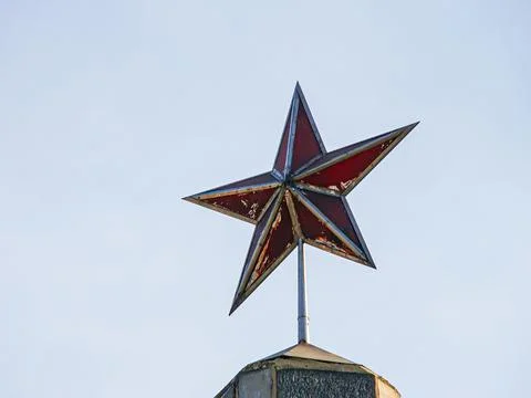 A vibrant, five-pointed star made of alternating red and yellow stars is mo.. Stock Photos