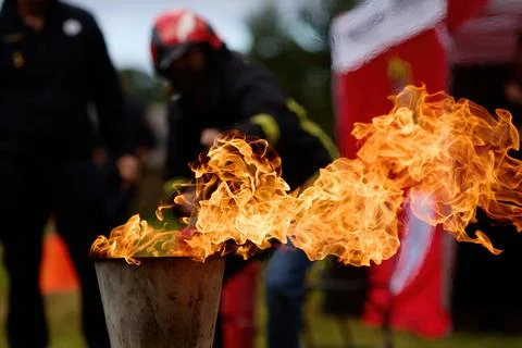 Vibrant Flame. Firefighters practice controlling an outdoor fire with Stock Photos