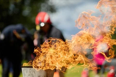 Vibrant Flame. Firefighters practice controlling an outdoor fire with Stock Photos
