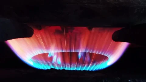 Vibrant flames glow beneath a dark burner Stock-Footage 341411638