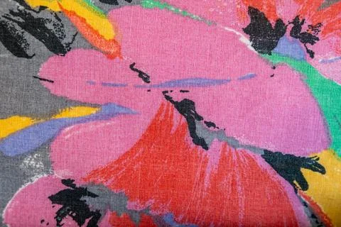Vibrant floral pattern with pink, red, and yellow hues on textured fabric, ideal Stock Photos