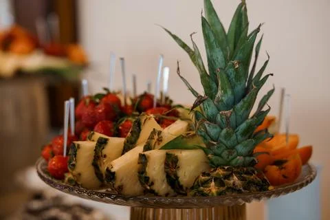 Vibrant Fruit Platter Display with Pineapple, Strawberries, Oranges, and Sk.. Stock Photos