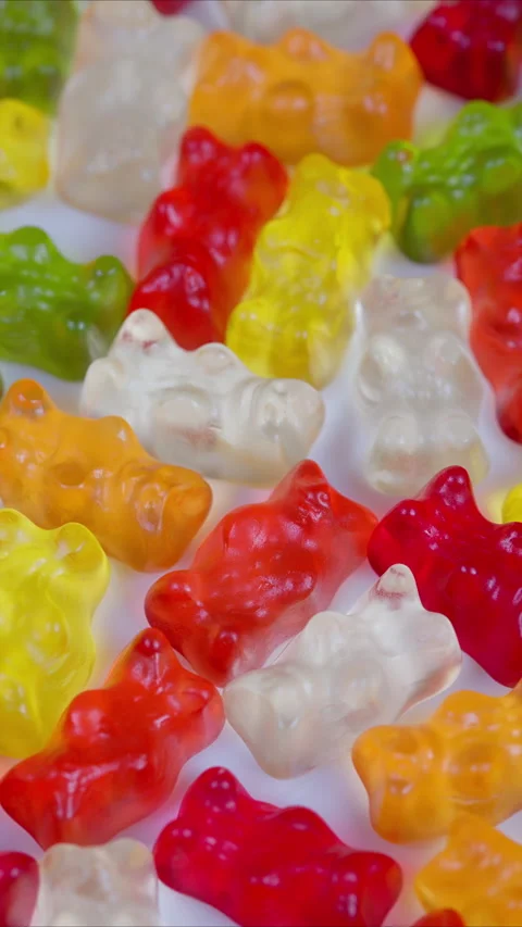 Vibrant gelatin sweets backdrop. Bright gummy bear assortment for packaging. Viv Stock Footage 333816689