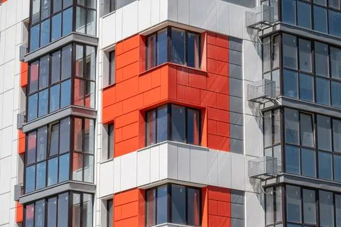 Vibrant geometric patterns dance across the facade of a modern building, show Stock Photos