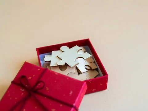 Vibrant gift box filled with assorted puzzle pieces perfect for inspiring c.. Stock Photos