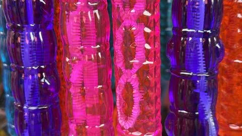 Vibrant, glossy plastic tubes featuring abstract patterns in purple, pink, an Stock Photos