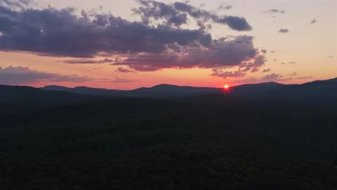 Vibrant golden hour sunset red sun on horizon Adirondack Mountain layer Schroon Stock Footage 342584883