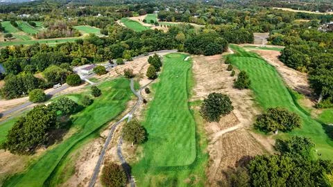 Vibrant golf course landscape showcasing lush greens and earthy textures Stock Photos
