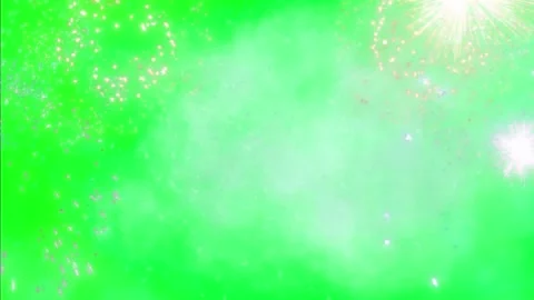 Vibrant green fireworks explode in clear evening sky Video stock 338222101