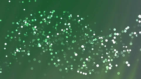 Vibrant green glittering particles creating a sparkling dynamic background .. Stock Footage 327060962