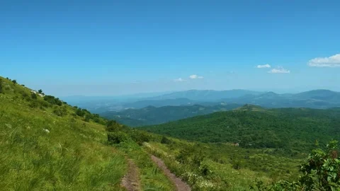 Vibrant green hills roll under clear blue sky. Mount Rtanj, Serbia Stock Footage 342314574